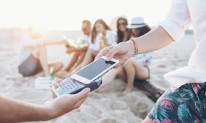 Mobile contactless payment on beach (c)iStock